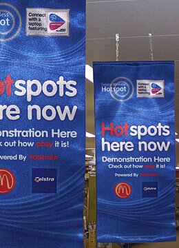 Custom cloth banner suspended for indoor display. Perfect for retail spaces, event promotions, and trade show environments.