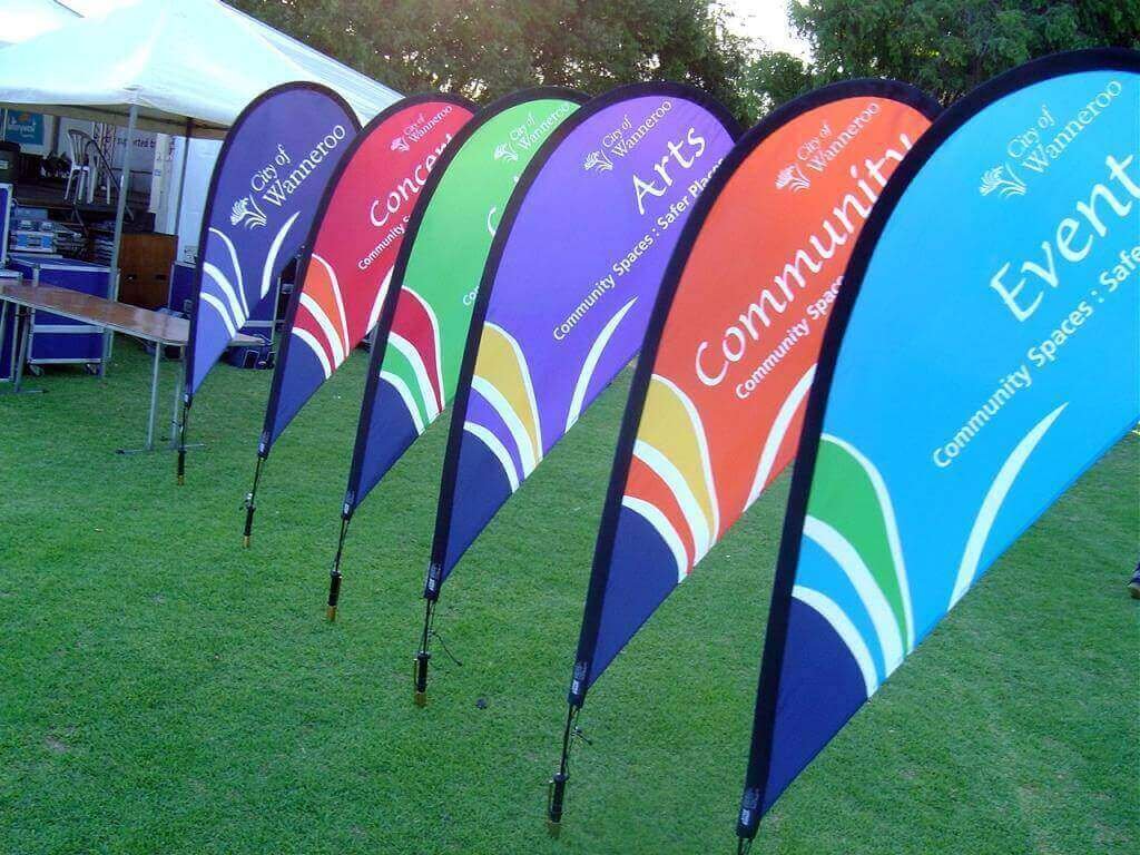 Colorful custom teardrop banners designed with coordinated branding and graphics for outdoor events, promotions, community gatherings, and directional displays. 